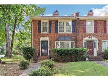 Charming brick townhouse with well-manicured lawn and tidy landscaping with brick exterior at 967 Chippendale Ln, Norcross, GA 30093