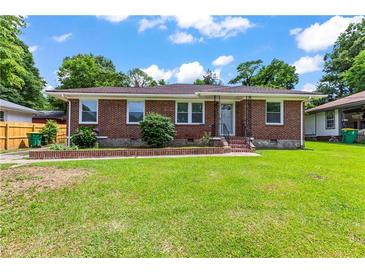 Charming brick ranch with a well-manicured lawn and inviting front entrance at 821 Springvalley Dr, Forest Park, GA 30297