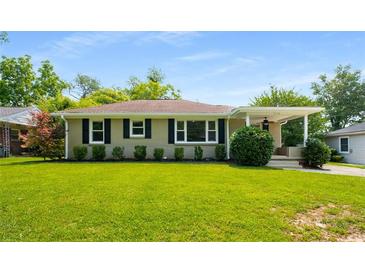 Charming one-story home with a well-manicured lawn and inviting curb appeal with a covered porch at 2288 Scotty Cir, Decatur, GA 30032