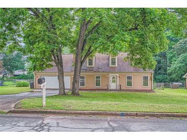 Charming one-story home featuring a manicured front yard and attached two car garage at 1739 Brandy Woods Se Trl, Conyers, GA 30013