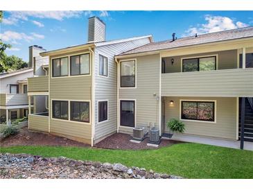 Charming condo with a well-maintained lawn, beautiful stonework, and a neutral-colored exterior at 3428 Ivys Walk, Atlanta, GA 30340