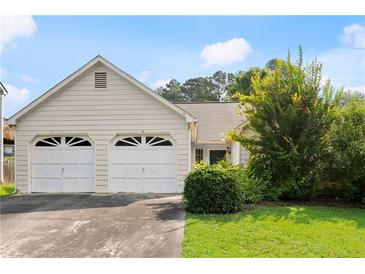 Charming single-Gathering home with a two-car garage and well-maintained lawn at 2806 Vintage Wood Nw Way, Kennesaw, GA 30144