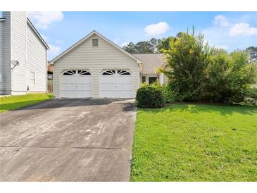 Charming single-Gathering home featuring a two-car garage and a well-maintained front yard with healthy green grass at 2806 Vintage Wood Nw Way, Kennesaw, GA 30144