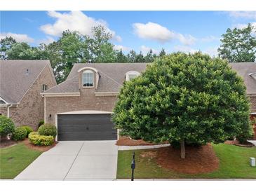 Charming brick home with a well-manicured lawn and a two-car garage at 123 Meridian Dr, Woodstock, GA 30188