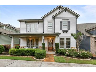 Charming two-story home with a covered front porch, landscaped yard, and a combination of siding and stone accents at 2013 White Cypress Ct, Smyrna, GA 30082
