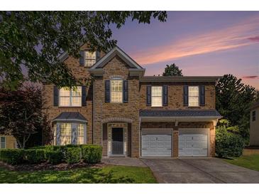 Charming two-story home with a stone facade, a two-car garage, and professionally landscaped front yard at 3533 Aberdeen Way, Douglasville, GA 30135