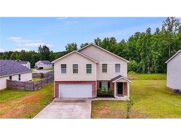 Inviting two-story home with a brick-accented facade and attached two-car garage at 510 Abeer St, Temple, GA 30179
