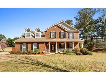 Charming two-story brick home with a welcoming front porch and well-maintained landscaping at 151 River Park Cir, Mcdonough, GA 30252