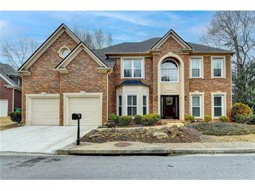 Beautiful two-story brick home with a two-car garage and well-maintained landscaping at 2730 Henderson Chase Ct, Tucker, GA 30084