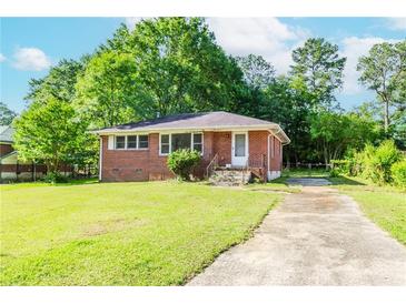 Charming brick home featuring a well-maintained lawn and a classic single-story design at 1167 Sanders Dr, Morrow, GA 30260