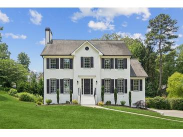 Charming two-story home features a white brick facade, black shutters, and a well-manicured lawn at 2907 Wickford Dr, Kennesaw, GA 30152