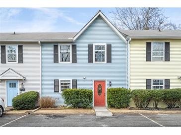 Charming townhome with colorful exterior, well-maintained landscaping, and convenient parking at 2859 Spring Villa Se Ln, Smyrna, GA 30080