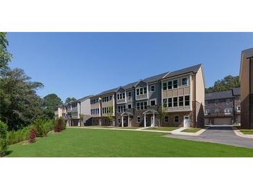 New construction townhomes feature manicured lawns and inviting entrances with a mix of stone and siding at 3774 Jack Vernon Cir, Powder Springs, GA 30127