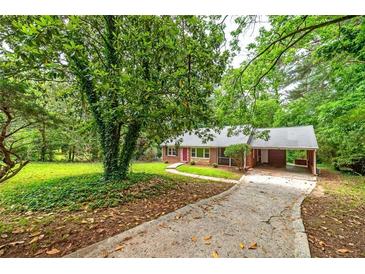 Charming brick home with carport and mature trees in a serene setting at 3080 Lynhurst Cir, Atlanta, GA 30311