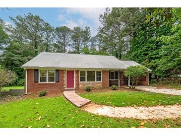 Charming brick home features a well-manicured lawn and a cozy front porch at 3080 Lynhurst Cir, Atlanta, GA 30311
