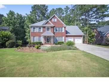 Charming two-story brick home with a manicured lawn and two-car garage at 4525 Cavallon Nw Way, Acworth, GA 30101