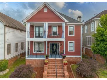 Charming two-story home featuring double balconies, brick stairs, and a professionally landscaped front yard at 121 Fulton Se Way, Atlanta, GA 30312