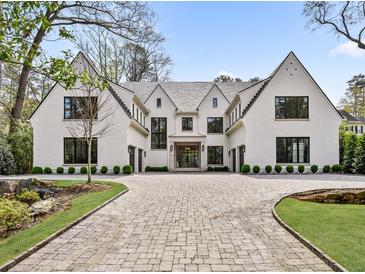 Stunning modern home with a brick driveway, manicured lawn, and professionally landscaped garden at 258 Pineland Nw Rd, Atlanta, GA 30342