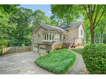 Charming multi-level home with a bay window, attached two-car garage, and lush landscaping at 2666 Peachtree Walk, Duluth, GA 30096