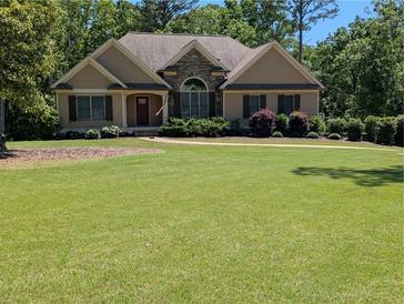 Charming single-story home featuring stone accents and a well-manicured lawn at 212 Wilshire Ter, White, GA 30184