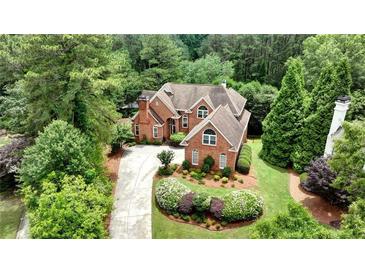 Stunning brick home with lush landscaping and a curved driveway at 119 Kennemer Ct, Duluth, GA 30097