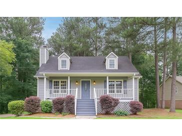 Charming home with a cozy front porch, dormer windows, and a well-maintained lawn with mature trees at 19 Willowbrook Ct, Acworth, GA 30101