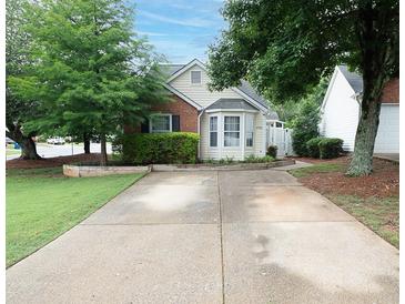 Charming home with a well-manicured lawn, beautiful trees, and a welcoming front exterior at 2790 Barnwood Xing, Duluth, GA 30097