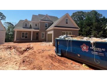 New brick home construction with gray trim, new windows, and a large blue Republic Services dumpster at 2753 S Waterworks Rd, Buford, GA 30518