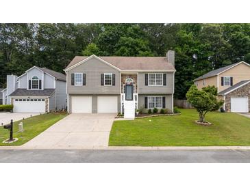 Charming two-story home featuring a well-maintained lawn and inviting front entrance at 1087 Berkley Se Dr, Smyrna, GA 30082