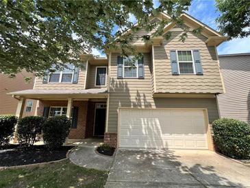 Inviting two-story home features a two-car garage, neutral siding, and charming curb appeal at 3522 Fallen Oak Dr, Buford, GA 30519