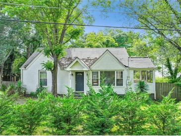 Charming one story brick home with mature trees and inviting front yard landscaping at 511 Ashburton Ave, Decatur, GA 30032