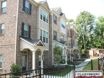 Attractive brick townhomes with well-maintained landscaping and welcoming entranceways at 2530 Clairebrooke Bend, Atlanta, GA 30341