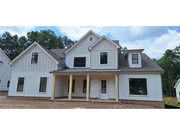 Charming two-story home featuring a welcoming front porch with sturdy columns and a classic white facade at 4625 Greyson Manor Dr, Cumming, GA 30041