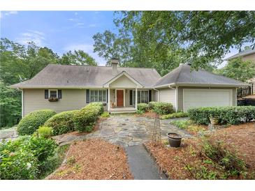Charming single-Gathering home with stone walkway and well-manicured landscaping for great curb appeal at 5065 Nesbit Ferry Ln, Atlanta, GA 30350