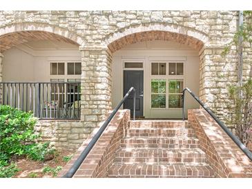 Inviting front entrance featuring brick stairs, stone archway, and well-maintained landscaping at 625 Piedmont Ne Ave # 105, Atlanta, GA 30308