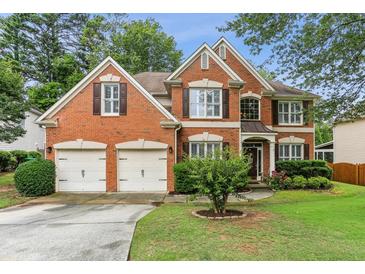 Charming two-story brick home with a well-manicured lawn and a two-car garage at , Atlanta, GA 30360