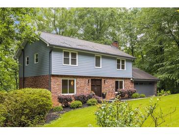 Charming two-story home with a well-manicured lawn, brick accents, and attached two car garage at 2892 Guinevere Ne Dr, Atlanta, GA 30345