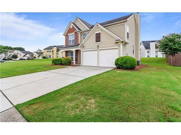 Charming two-story home featuring a well-manicured lawn and a two-car garage at 8970 Ruel Ln, Suwanee, GA 30024