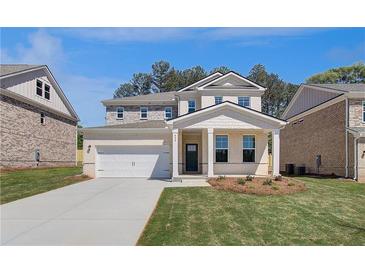 Charming two-story home featuring a two-car garage and well-manicured front lawn at 640 Leafy Branch Way, Mcdonough, GA 30253