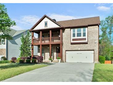 Charming two-story brick home with a double porch and two car garage at 1610 Apollo Dr, Suwanee, GA 30024