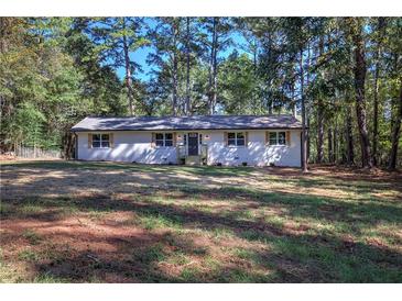 Charming, newly renovated single-story home featuring a white brick facade and a lush front yard at 380 Inman Rd, Fayetteville, GA 30215