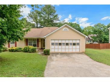 Charming single-story home featuring a well-manicured lawn and attached two-car garage at 9550 Canvasback Ct, Jonesboro, GA 30238