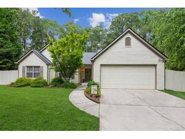 Charming single-story home featuring a well-maintained lawn, brick accents, and a two-car garage at 2277 Lazy Days Rd, Dacula, GA 30019