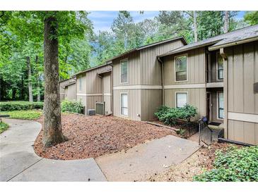 Charming townhome featuring a well-maintained lawn, mature trees and a serene, wooded setting at 8740 Roswell Rd # 2G, Atlanta, GA 30350