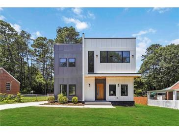 Modern two-story home with gray and white siding, black trim windows, and lush green lawn at 1554 Columbia Cir, Decatur, GA 30032
