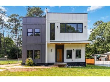 Striking two-story home with a modern design, featuring mixed siding and large windows at 1554 Columbia Cir, Decatur, GA 30032