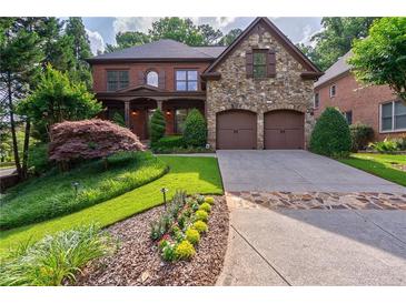 Beautiful two-story brick home featuring a stone facade and an attached two-car garage at 1984 Mendenhall Cir, Atlanta, GA 30341