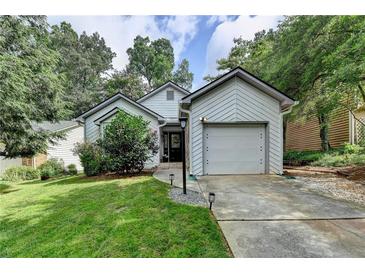 Charming single-story home featuring a well-maintained lawn, attached garage, and inviting curb appeal at 1133 Capital Club Ne Cir, Brookhaven, GA 30319