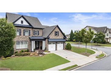 Charming brick home boasts a manicured lawn, two-car garage, and inviting curb appeal at 4010 Cameron Ct, Cumming, GA 30040