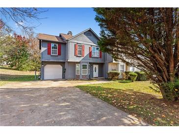 Charming two-story home with gray siding, red shutters, attached garage, and a well-manicured front lawn at 3775 Reston Ln, Decatur, GA 30034